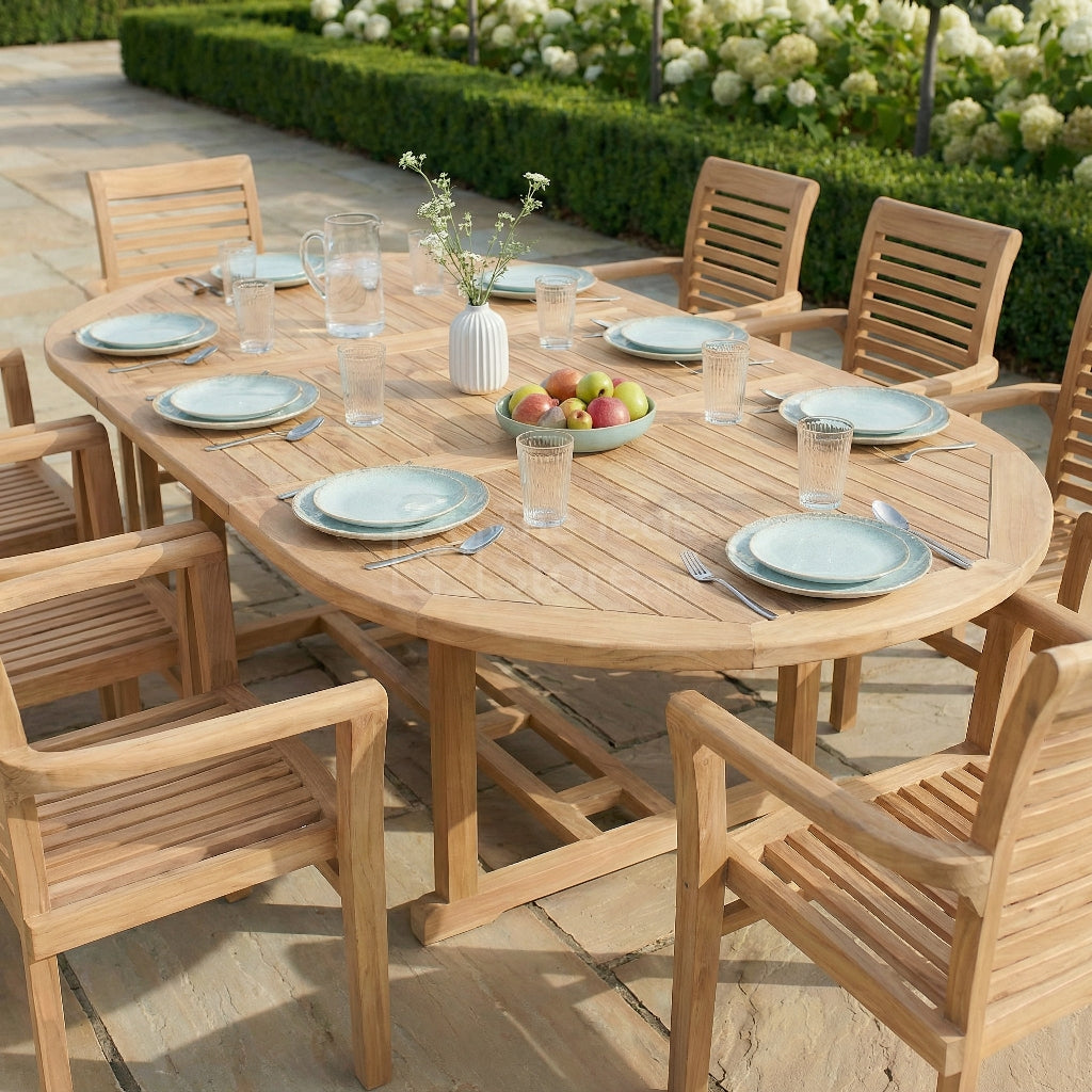 Wooden outdoor dining table set with chairs on a patio