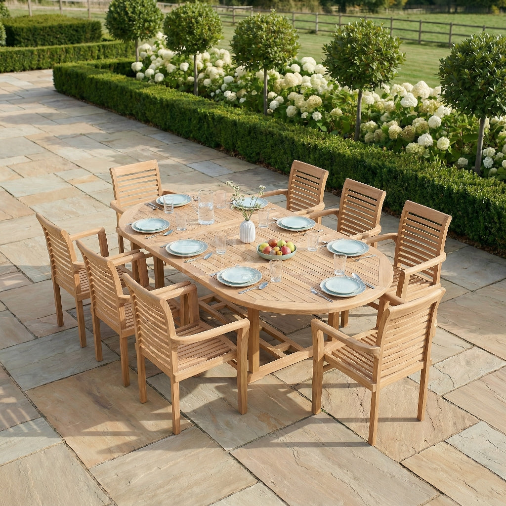 Wooden outdoor dining set on a stone patio with garden in the background