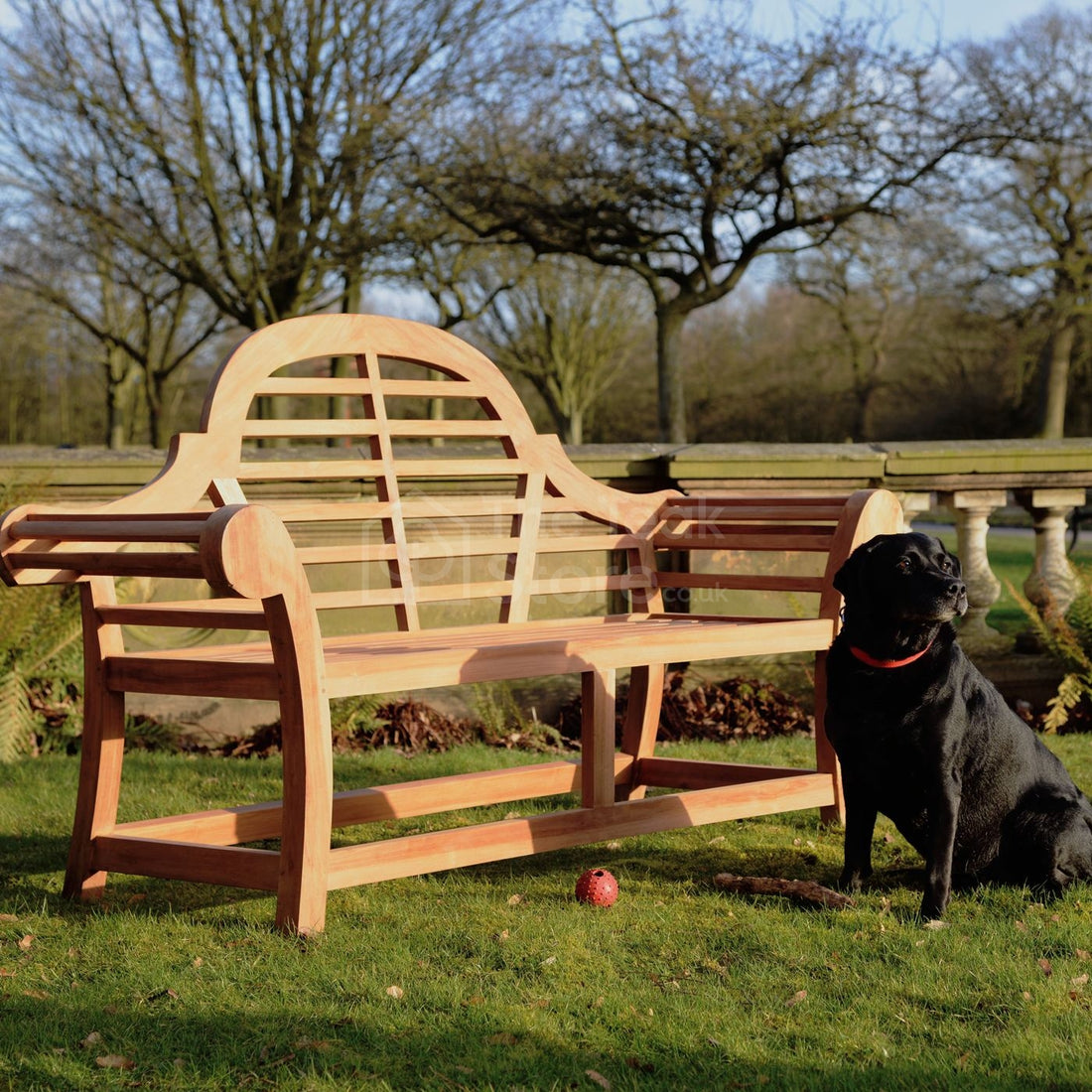 Kyoto Edo 3-seater teak garden bench with dog resting beside it in a peaceful outdoor setting