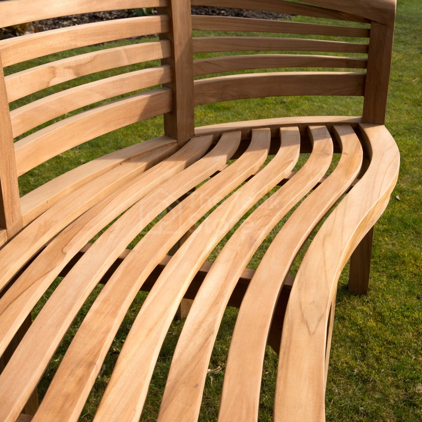 Close-up of Lewes teak bench backrest with finely crafted curved slats.
