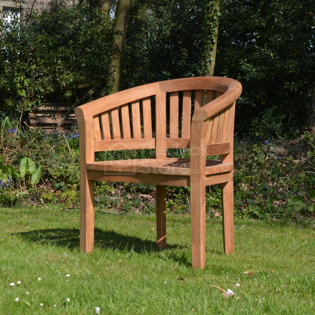 Rear angled view of the Lulworth Teak Banana Garden Chair showing full curve and solid teak construction.
