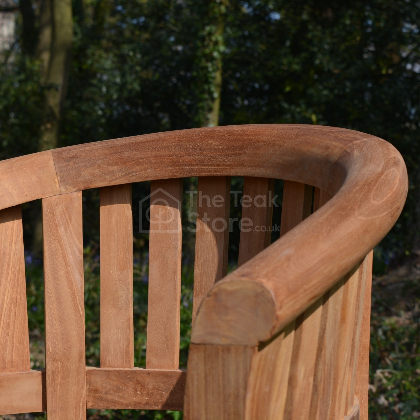 Close-up of the rounded top rail and smooth grain on the arm of the Lulworth Teak Banana Chair.